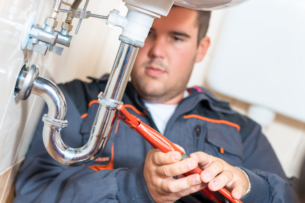 Plumber tightening pipe joint